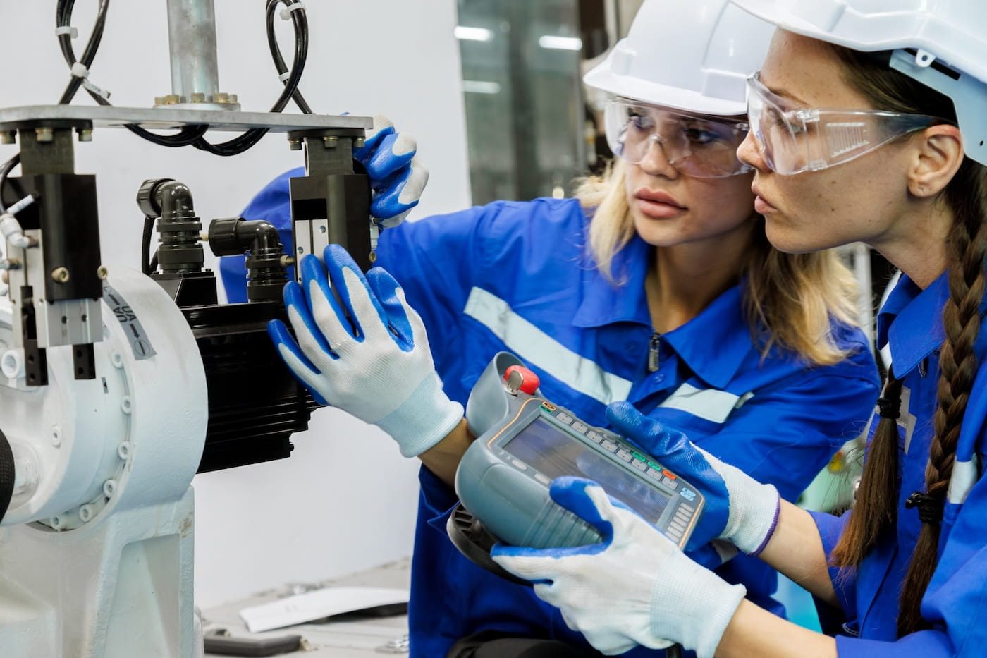 engineers inspecting robotic equipment in a smart factory setting illustrating how mood aware environments use real time sensing and automation to support worker well being and performance under industry 5.0 principles