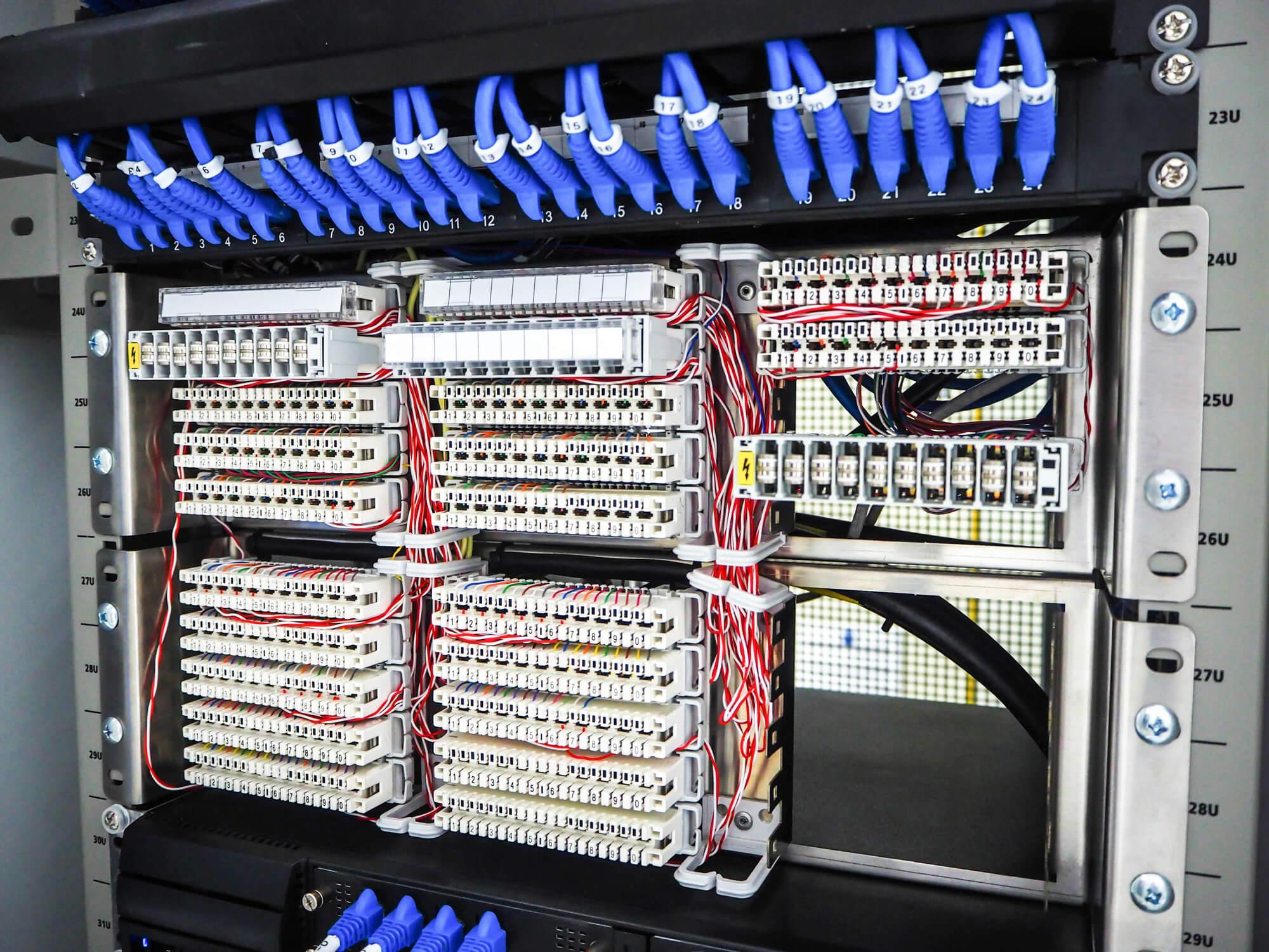 wired industrial control panel with organized circuits and components, representing disciplined OT design and resilient system architecture